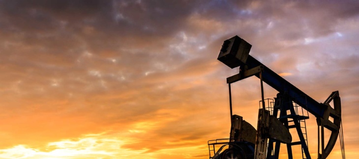 Profile of oil well at sunset