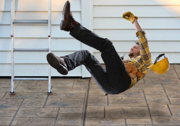 Worker falling from ladder onto floor