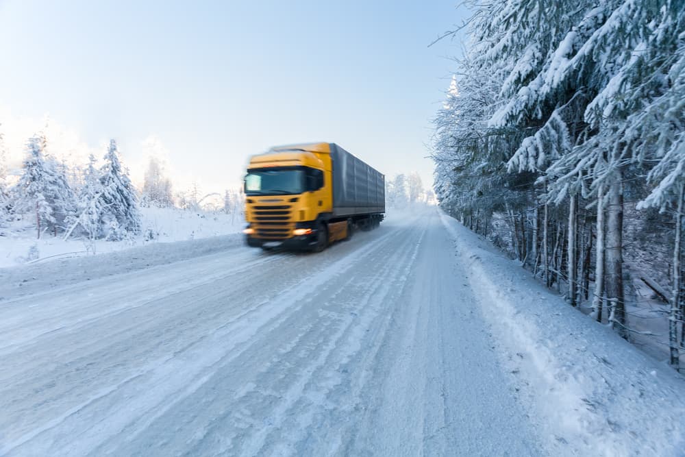 A truck on winter road on frosty day