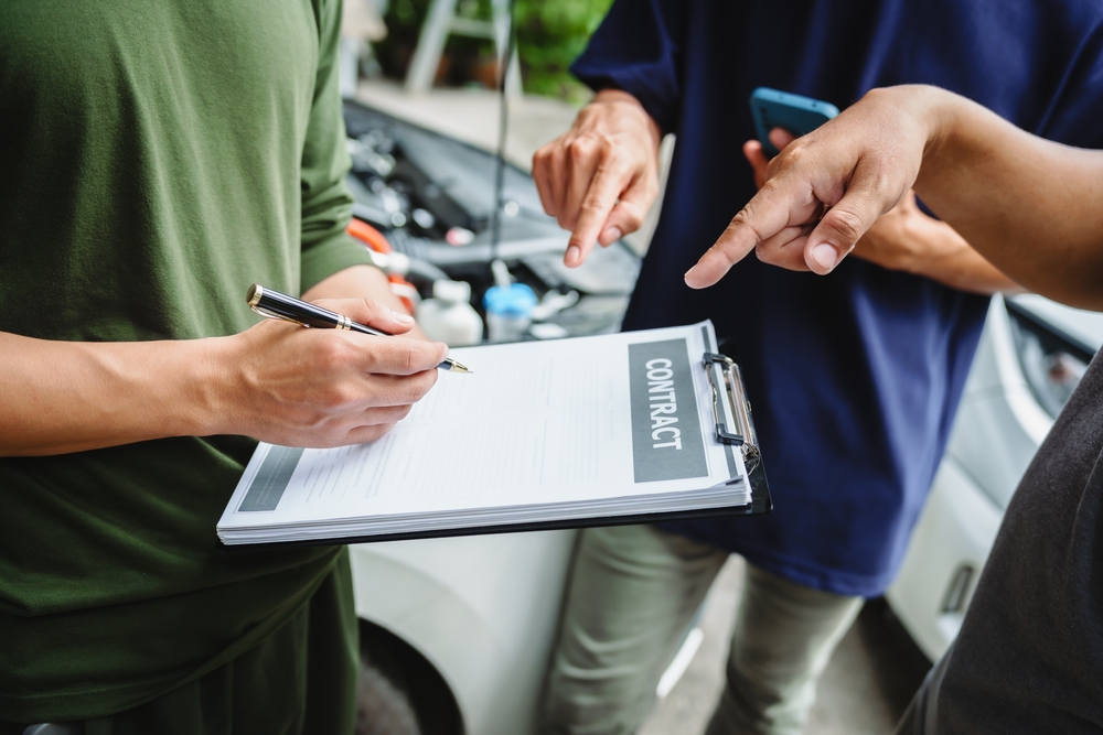 Graphic showing a person contemplating an insurance settlement offer after a car accident; think before acting.