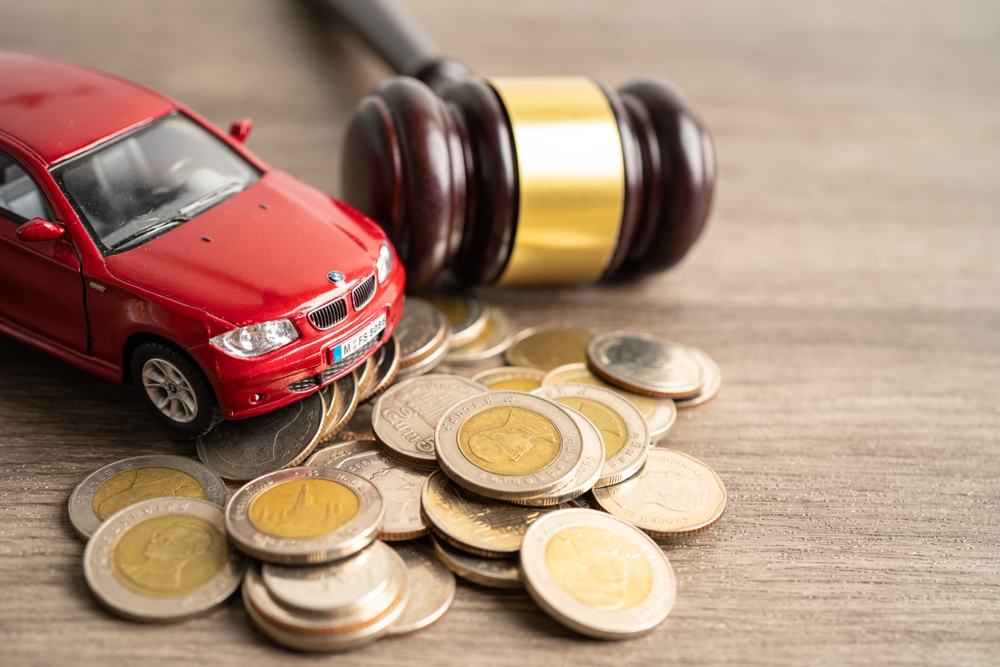 judge and money with car vehicle accident, insurance coverage claim lawsuit court case.