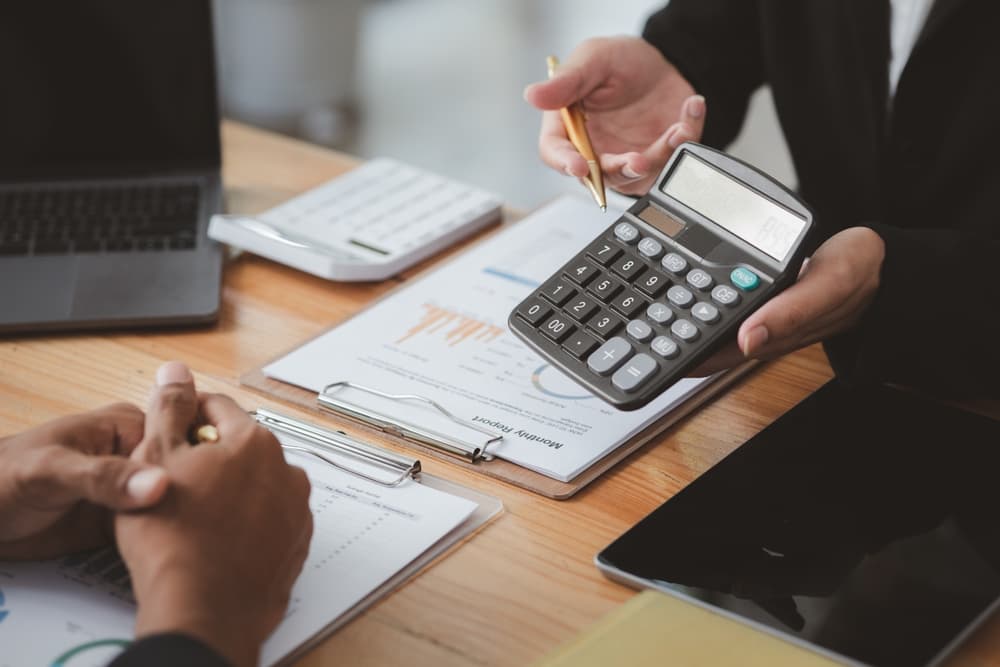 person showing costs of legal fees on calculator