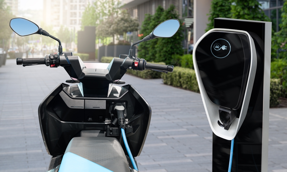 Scooter parked on a city street, showcasing its lightweight frame and low center of gravity for easy handling.