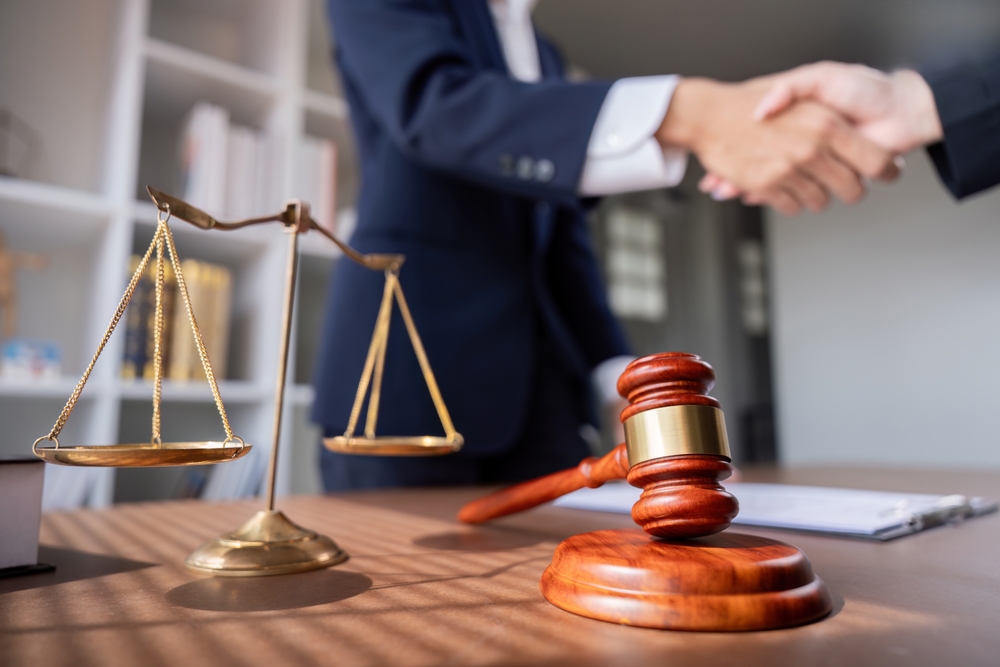 Personal injury lawyer meeting with a client to discuss legal options after an accident and fault determination.