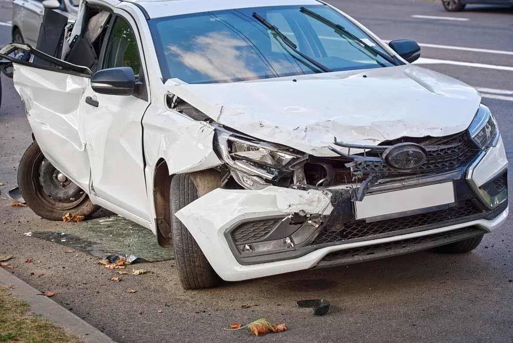 Severely damaged , broken headlights after road incident. Car with severe damage.