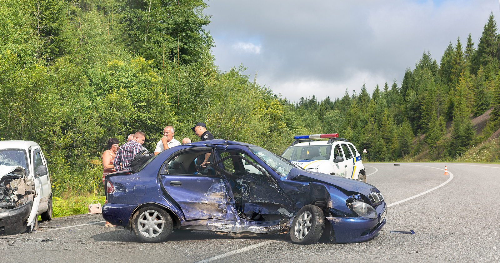 Fatal traffic accident. Real event. Two cars crashed on the road. Police officer interrogates participants and witnesses of road accident